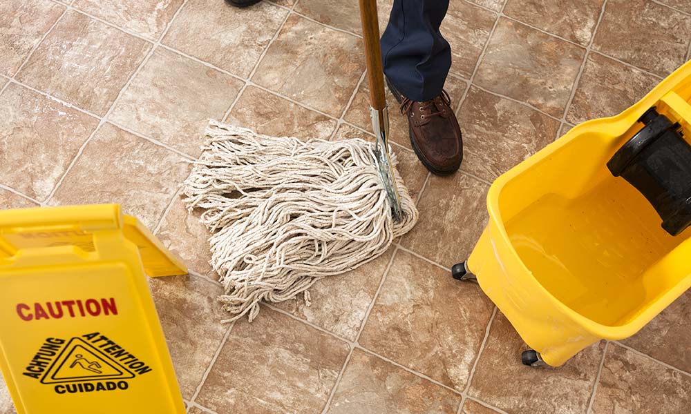 Mop being pushed on tile floor