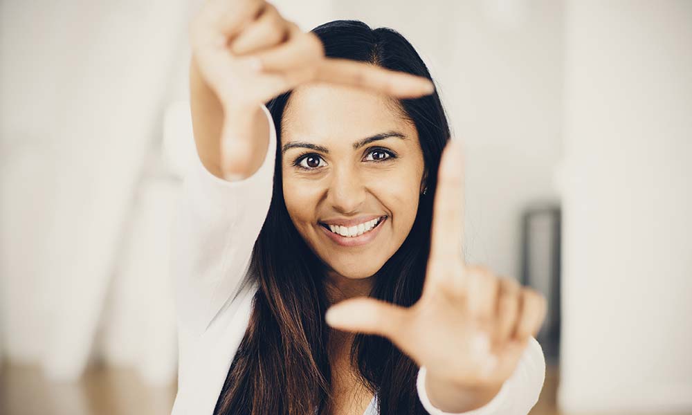 Woman framing her subject with her hands