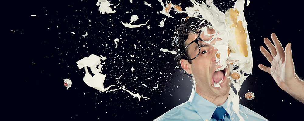 Man getting hit in the face with pie