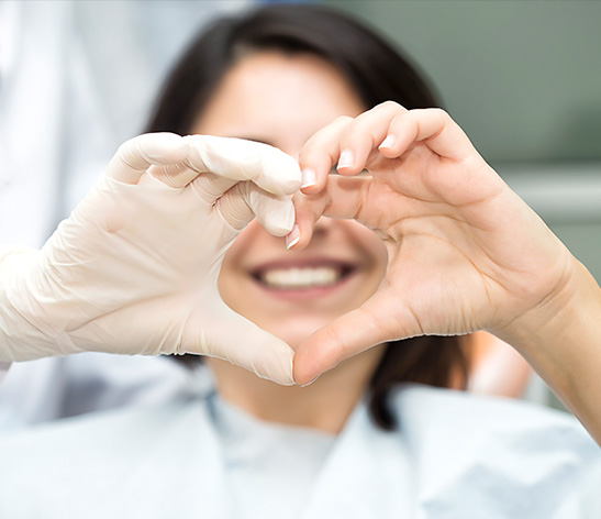 doctor making a heart with her hands