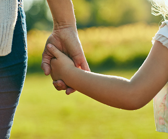 Two individuals holding hands