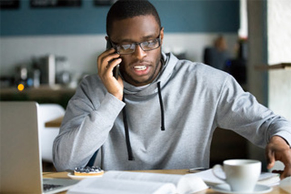 Man in gray hoodie on the phone