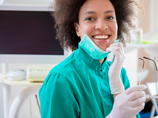 Woman in scrubs holding glasses