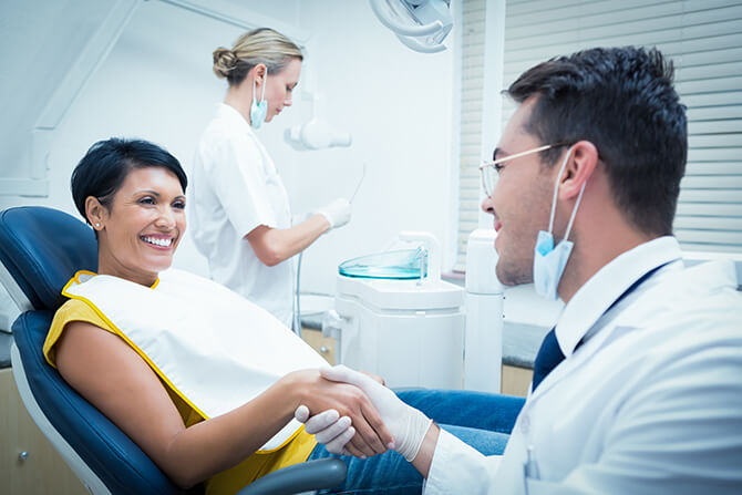 dentist shaking a patient's hand