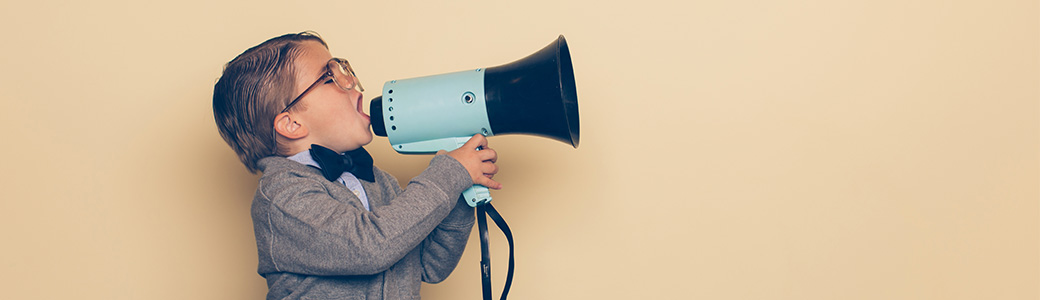 little boy shouting into a megaphone