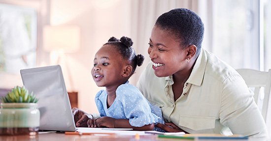 mother and daughter looking at a computer together